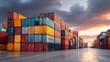 © Dara - A large stack of colorful shipping containers on a concrete dock at sunset.