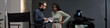 © TrueFrame Collective - Caucasian middle aged man holding script and talking with young adult Black woman during acting audition on studio set, both standing near director chair and professional video camera