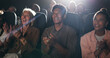 © Wesley25/peopleimages.com - Applause, happy and audience in theatre for movie, comedy show and reaction for film in cinema. Laughing, entertainment and group of men and women for motion picture, premiere success and approval