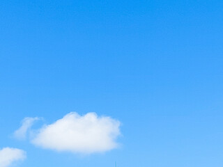 Wall Mural - Soft white clouds with a beautiful blue sky in the morning light. Soft white clouds float in the clear blue sky. Clear blue sky, bright spring, soft sky gradient.