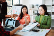 © Dino - Brainstorming of young modern group. Team meeting to achieve goal. Business people discussing finance business and analysis. Teamwork concept in modern office. Calculating personal tax for client.