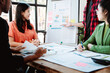 © Dino - Brainstorming of young modern group. Team meeting to achieve goal. Business people discussing finance business and analysis. Teamwork concept in modern office. Calculating personal tax for client.
