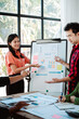 © Dino - Brainstorming of young modern group. Team meeting to achieve goal. Business people discussing finance business and analysis. Teamwork concept in modern office. Calculating personal tax for client.