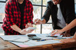 © Dino - Brainstorming of young modern group. Team meeting to achieve goal. Business people discussing finance business and analysis. Teamwork concept in modern office. Calculating personal tax for client.