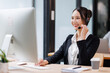 © David - Asian Woman Wearing Headset Sitting At Desk Working In Office Call Centre Team