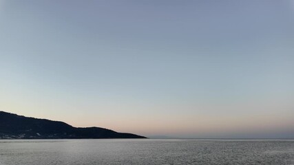 Wall Mural - sunrise on the coast with calm, rolling waves