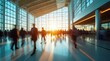 © Alex Pios - A time-lapse of a busy modern airport terminal with blurred travelers walking.