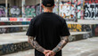© SalmanStock - Urban Black T-Shirt Mockup - Back View of Tattooed Man in Street Art Graffiti Background for Apparel Branding and Fashion Design