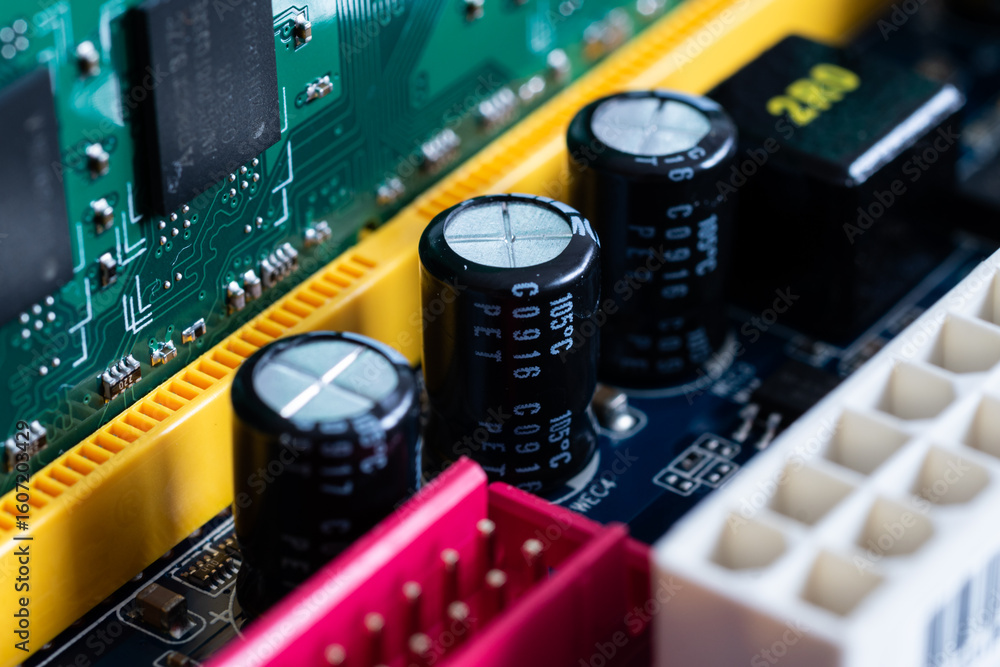 Capacitors or condensers in row on motherboard close up, electronic ...