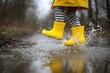 © Harry - Child in yellow rain boots jumping in puddle