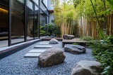 Modern zen garden with gray gravel, stepping stones, and large rocks