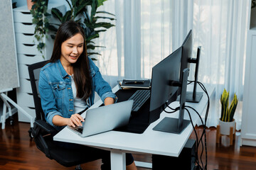 smiling young asian in it developer creating with typing online information on laptop with coding pr