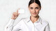 © taswar786 - Professional woman in white shirt holding a blank business card against a white background smiling