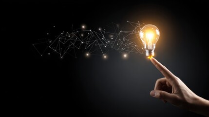 A glowing lightbulb is illuminated from a finger with connecting lines on dark background