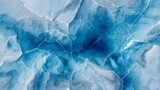An aerial view showcasing blue ice patterns with intricate cracks, highlighting the natural and crystalline structure of frozen water.
