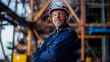 © Mehreen - dedicated maritime engineer wearing a navy-blue jumpsuit and a safety helmet, standing confidently in a bustling shipyard.