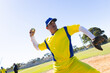 © Wavebreak Media - Male baseball player pitching baseball on mound at baseball field in yellow-blue uniform with glove