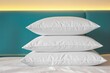 © lina - Stacked White Pillows Against Teal Headboard