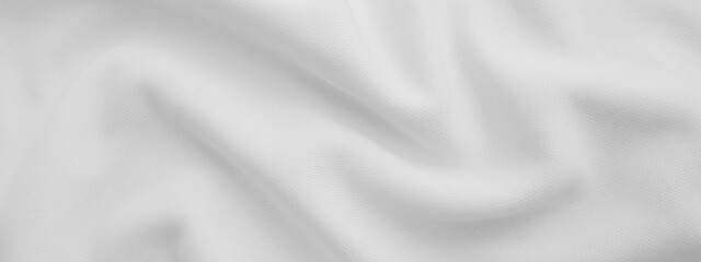 White wavy fabric background. Wrinkled cloth