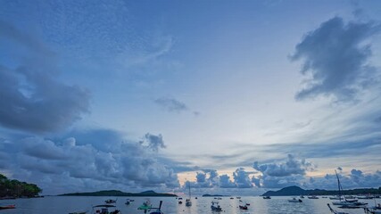 Wall Mural - Time lapse blue cloud in sunrise above fishing port. The sky is filled with blue clouds in the morning.
Blue clouds roll over the sea.
Fishing boats are lined up in the bay.
blue sky background.