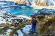 © Jakub - Brave hiker girl walks along alpine trail to Mueller Hut, admiring turquoise glacial tarns and stunning mountainous scenery, Aoraki Mount Cook National Park, Canterbury, South Island, New Zealand