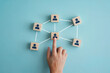 © Graphi - Conceptual Flat Lay of Interconnected Wooden Blocks with Human Icons Representing Teamwork and Communication