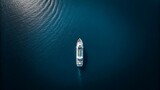 Aerial view of a white ship sailing on deep blue water