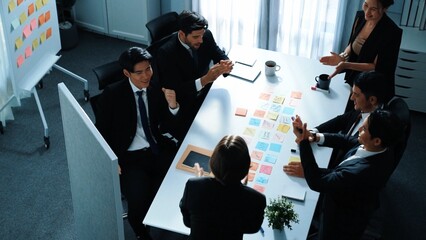 Wall Mural - top view of businesswoman present idea and pointing at whiteboard while putting hand together and cl