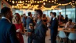 © Mahfuj - People mingling at a corporate event with champagne glasses and string lights in the background indoors