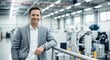© Farhan - Portrait of a confident manager or owner smiling in a modern factory. Successful businessman in the manufacturing and industrial sector.