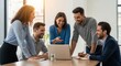 © Farhan - A cheerful diverse team working together on a laptop in a sunlit office. A creative group of colleagues collaborating on a business project.