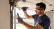 © Masaji - Man repairing garage door spring with wrench and pliers wearing safety glasses and gloves indoors near door frame