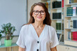 © Valerii Honcharuk - Headshot portrait smiling mature woman teacher in classroom
