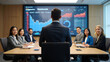© designworld24x7 - Business team in a modern conference room with a presenter facing a large screen displaying financial data and charts