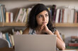 © fizkes - Indian woman working on laptop, looks focused and thoughtful, analyzing or reflecting on information, reviewing report, considering potential decisions or strategies for upcoming project or meeting