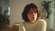 © bephoto - 女性が窓辺で涙をこぼす