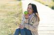 © luismolinero - Young woman at outdoors holding an apple