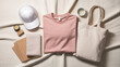© Nazmul Karim Sakib - A collection of everyday essentials including a pink tshirt, white cap, tote bag, and notebooks