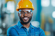 © Vilaysack - Smiling construction worker wearing hard hat and safety glasses, showcasing confidence and professionalism in work environment