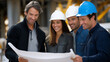 © Nataliya - Engineers reviewing blueprints on construction site under sunlight