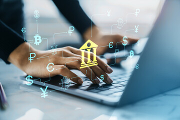 digital banking interface with currency symbols and person typing on laptop, representing fintech ne