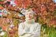 © annanahabed - Outdoor portrait of happy mature 55 - 60 year old woman in autumn park, wearing beige pullover.  Active and healthy lifestyle