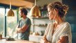 © aMichelle - A couple stands apart in a cozy kitchen, arms crossed and avoiding eye contact, revealing emotional tension.