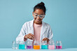 © Anastasiia Havelia - Young female pharmacist preparing child-friendly syrup, pastel background