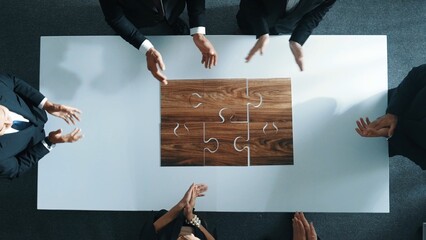 Wall Mural - top view of business people putting jigsaw together at meeting room. professional marketing team sta