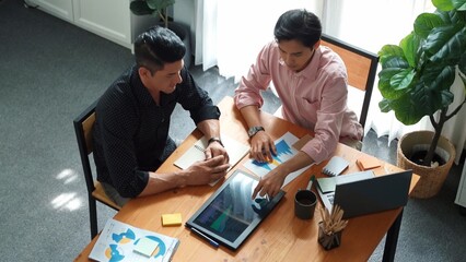 Wall Mural - top view of business team working together to analysis data by using tablet on meeting table. divers