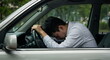 © Syartinolky | Works - Exhausted man rests his head on the steering wheel of his car