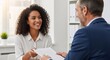 © dreamdes - Happy african american woman gives cv to male recruiter. Female job applicant passing resume to hiring manager at interview.