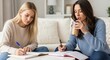 © Ura - Two Young Women Concentrating While Studying Together at Home or Library