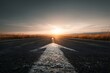 © Rifqi - Asphalt road with white arrow markings leading towards the horizon at sunset in rural landscape, concept for business strategy, future direction and road to success in achieving goals